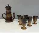 Jean Marais, service à café complet, en céramique de grès émaillé, des années 70 en excellent état. Signé sous la base pour cette grande cafetière ( 30cmX20 ) et à la main sous chaque mazagrans.                                                 Jean Marais, complete coffee service, in enameled stoneware ceramic, from the 70s in excellent condition. Signed under the base for this large coffee maker (30X20cm) and by hand under each mazagrans.